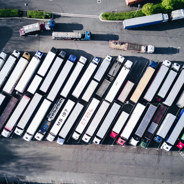 Aerial view of lorries parked in lot